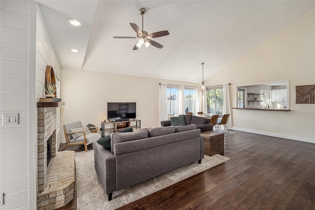 living room with a textured ceiling, dark hardwood / wood-style floors, high vaulted ceiling, and ceiling fan