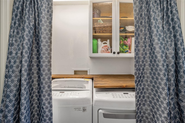 clothes washing area with independent washer and dryer