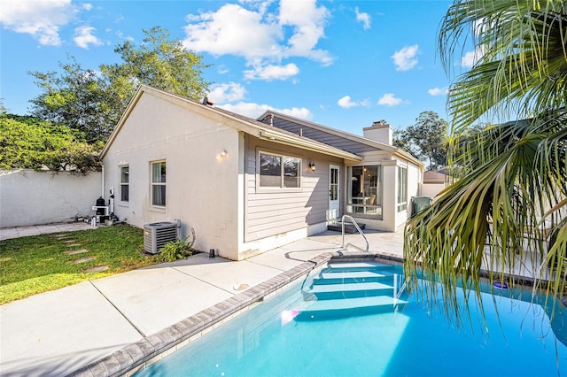 rear view of property with a patio and central AC