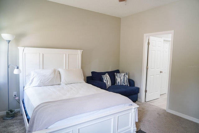 bedroom featuring light carpet and baseboards