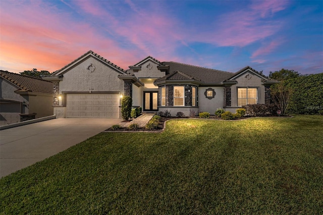 view of front of home featuring a yard and a garage