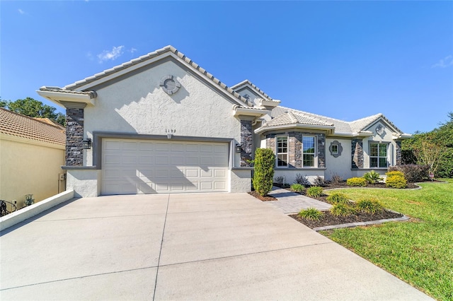 view of front of property with a front lawn and a garage