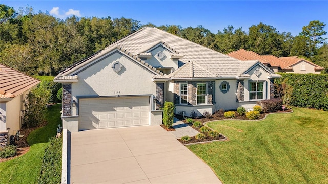 view of front of home with a garage and a front lawn