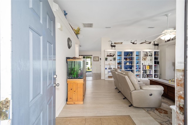 living room featuring ceiling fan and light wood-type flooring