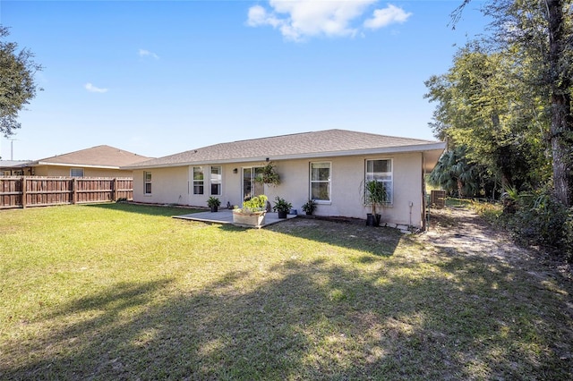 rear view of property with a patio area and a lawn