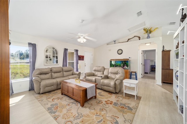 living room with light hardwood / wood-style flooring, ceiling fan, and vaulted ceiling