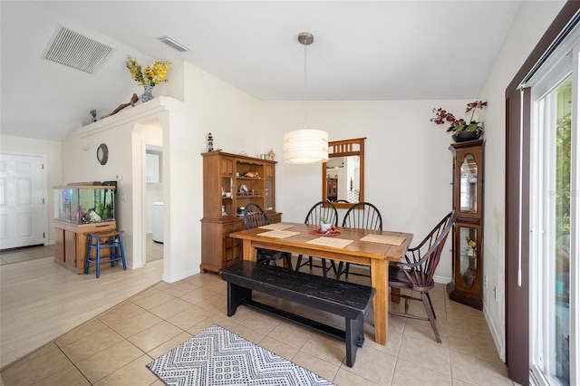 dining space featuring light hardwood / wood-style flooring and vaulted ceiling