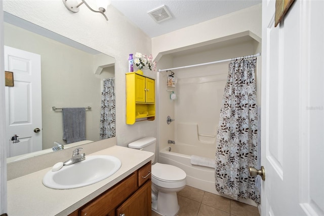 full bathroom with tile patterned floors, toilet, shower / tub combo with curtain, vanity, and a textured ceiling