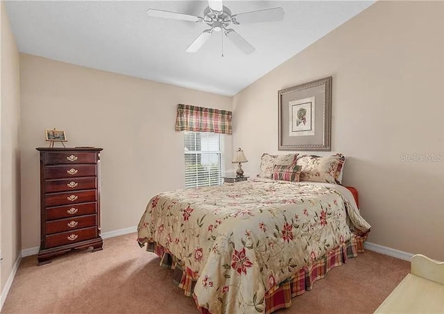 bedroom featuring lofted ceiling, light colored carpet, ceiling fan, and baseboards