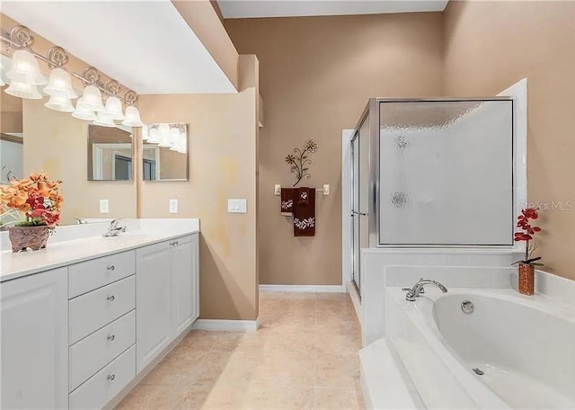 bathroom with a garden tub, tile patterned flooring, vanity, baseboards, and a stall shower