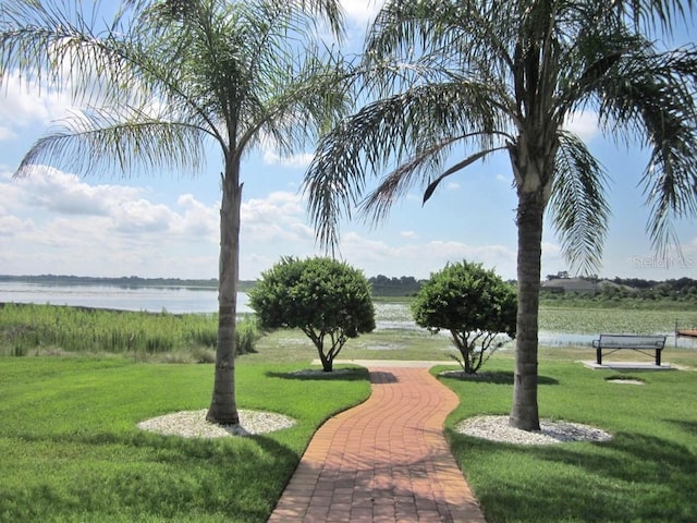 view of community featuring a yard and a water view