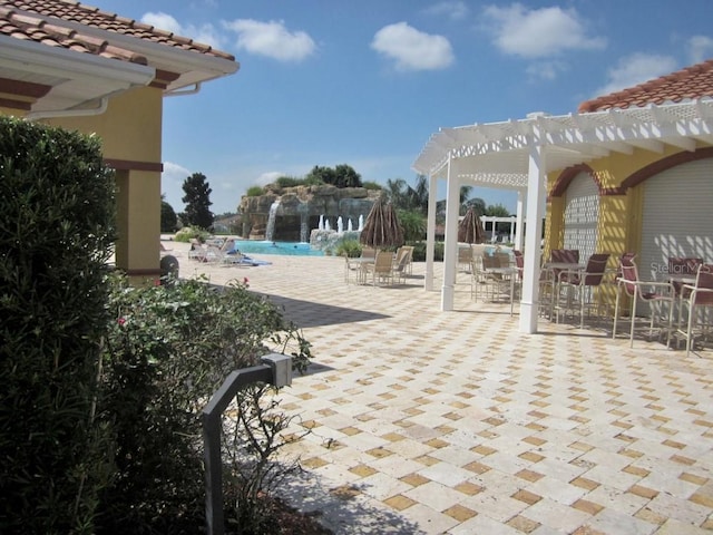 view of patio / terrace with a community pool and a pergola