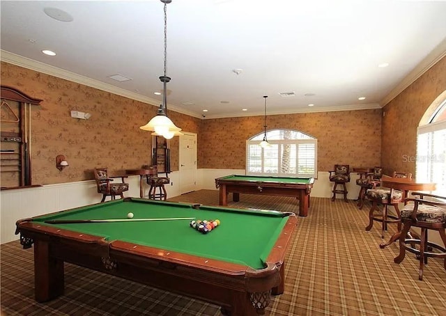 recreation room featuring carpet floors, wallpapered walls, ornamental molding, and wainscoting