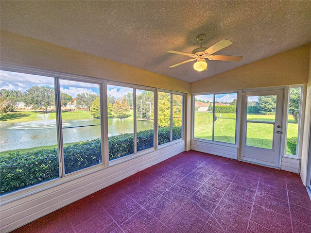 unfurnished sunroom with a wealth of natural light, lofted ceiling, and a water view