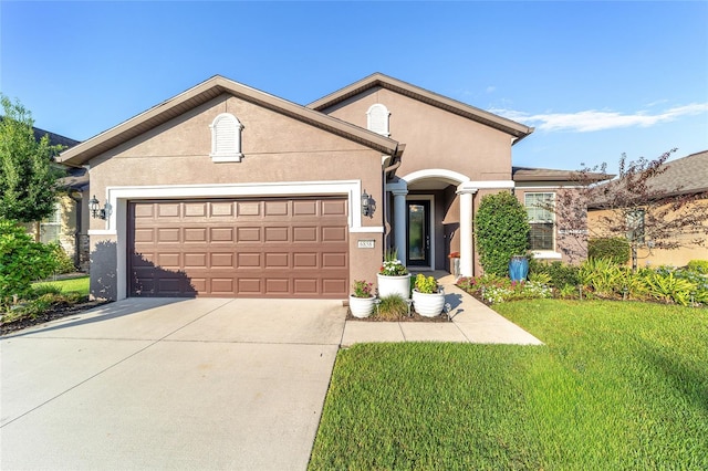 view of front of home featuring a front yard and a garage