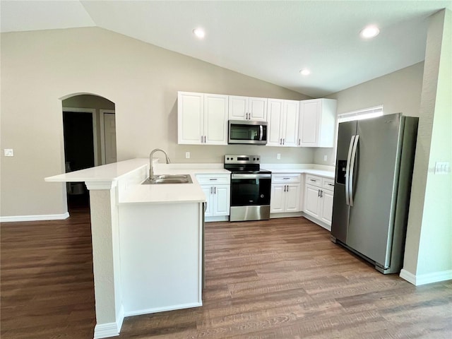 kitchen featuring appliances with stainless steel finishes, light countertops, a peninsula, and white cabinetry