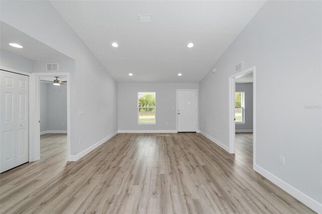 unfurnished living room featuring light wood-type flooring, baseboards, and visible vents