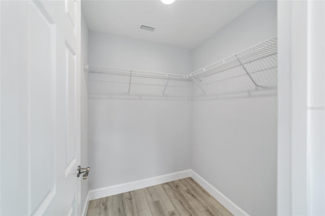 walk in closet featuring light wood-style flooring and visible vents