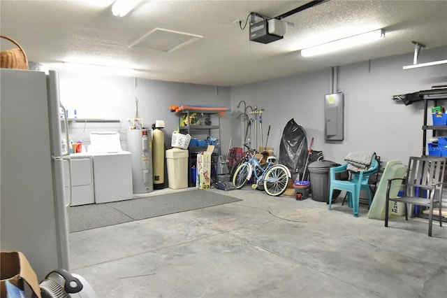 garage featuring electric panel, white fridge, water heater, washing machine and clothes dryer, and a garage door opener