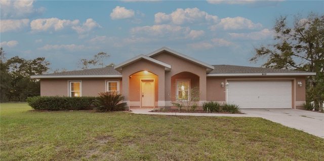 ranch-style home featuring a front lawn and a garage