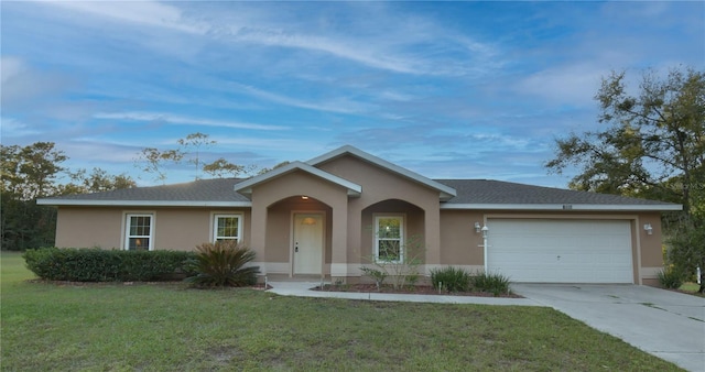 ranch-style house featuring a garage and a front yard