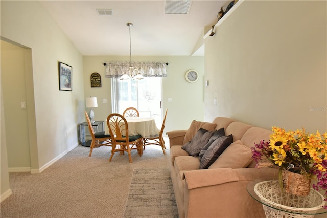 dining area with an inviting chandelier and light carpet