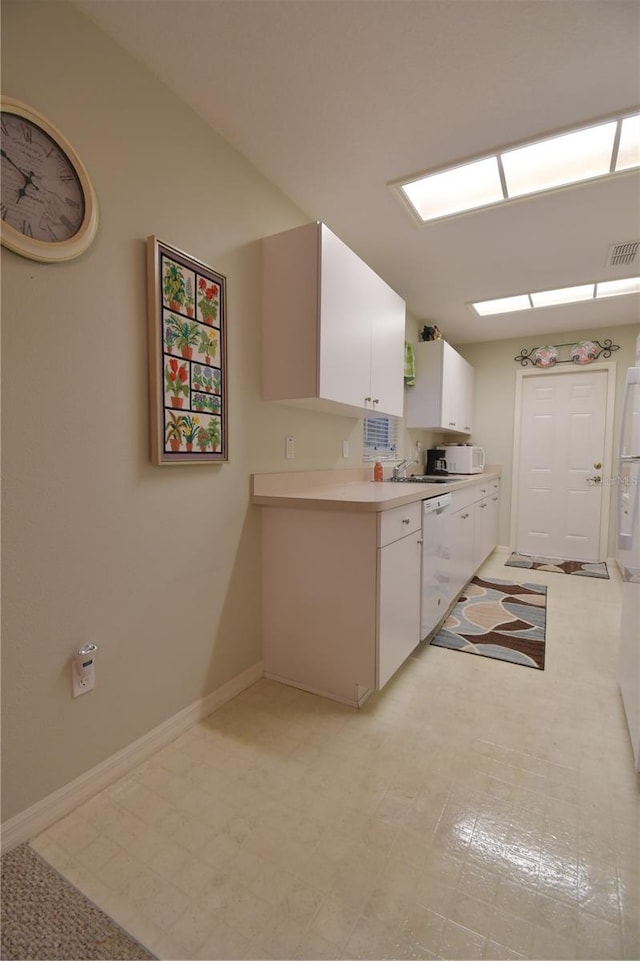 kitchen featuring white cabinetry, white appliances, and sink