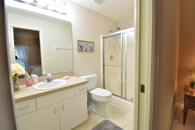 bathroom featuring walk in shower, vanity, and toilet