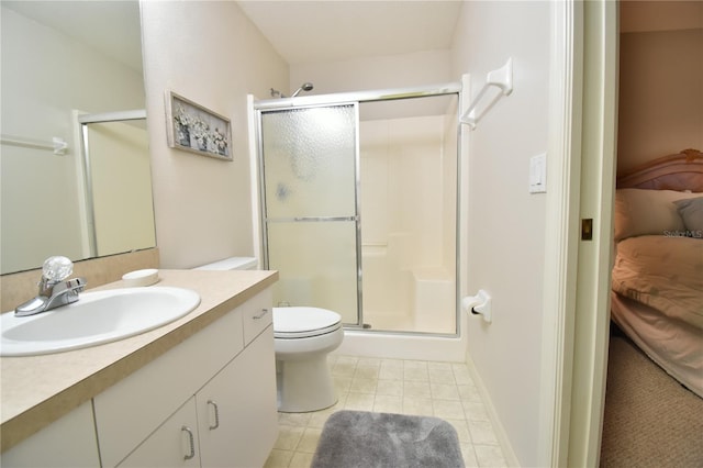 bathroom featuring tile patterned flooring, vanity, toilet, and a shower with shower door