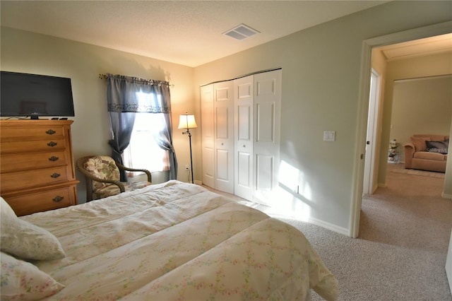 carpeted bedroom featuring a closet