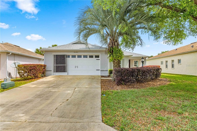 view of front of house with a front yard and a garage