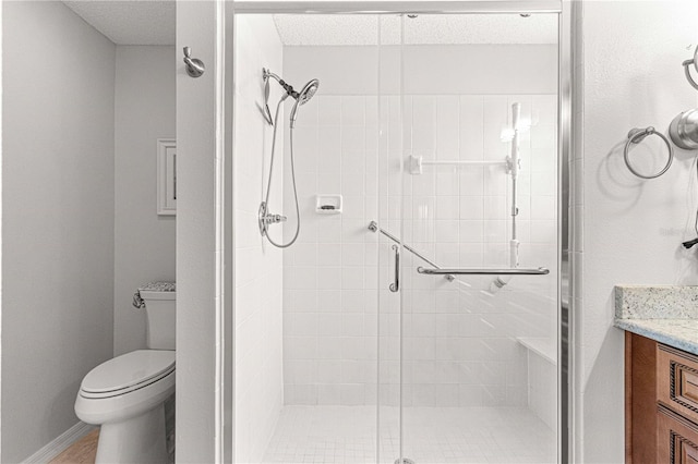 bathroom featuring vanity, toilet, and walk in shower