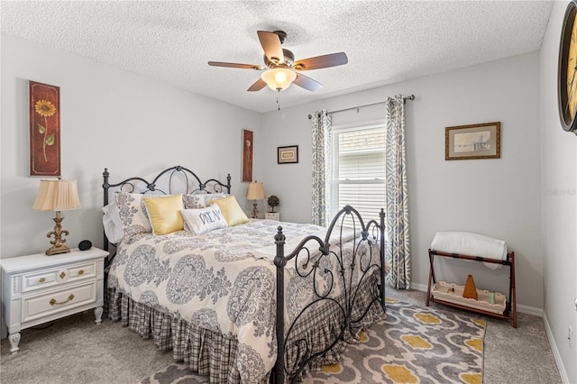 carpeted bedroom with a textured ceiling and ceiling fan