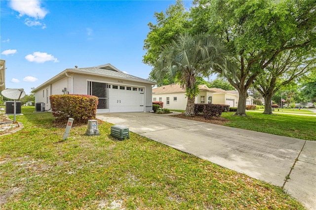 single story home with a front yard, central AC, and a garage