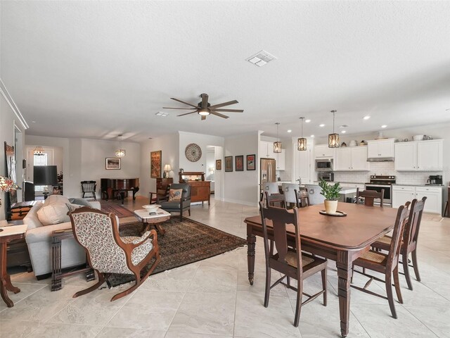 dining area with a textured ceiling and ceiling fan