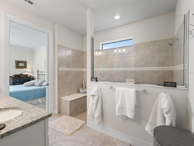 bathroom featuring vanity and a tile shower