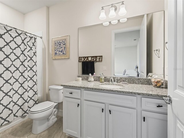 bathroom with vanity, a shower with curtain, and toilet