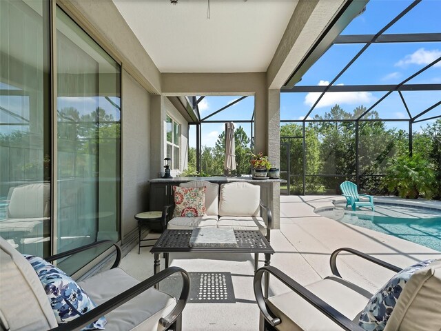 view of patio featuring a lanai