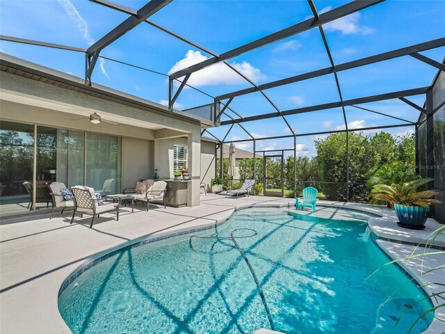 view of swimming pool with an outdoor hangout area, pool water feature, a patio area, and a lanai