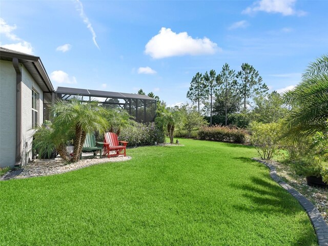 view of yard with glass enclosure