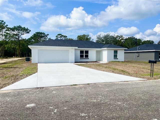 single story home with a front lawn and a garage