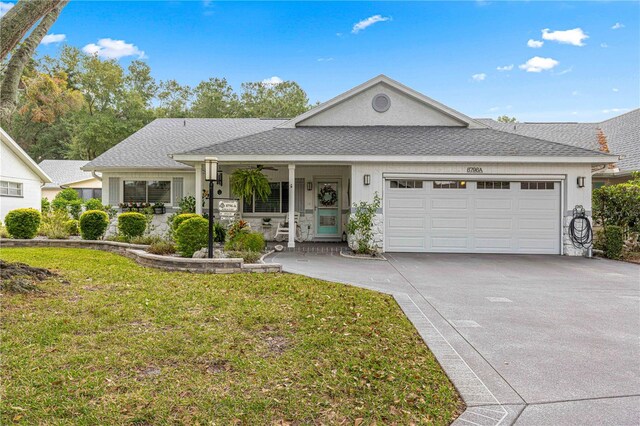 view of front of home featuring covered porch, a front lawn, and a garage