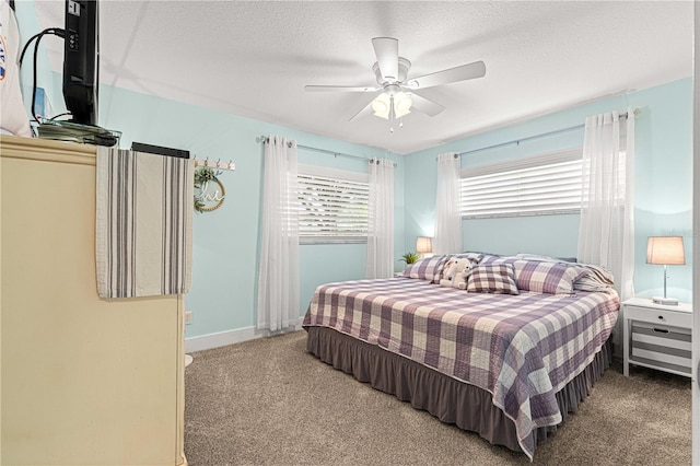 carpeted bedroom featuring a textured ceiling and ceiling fan