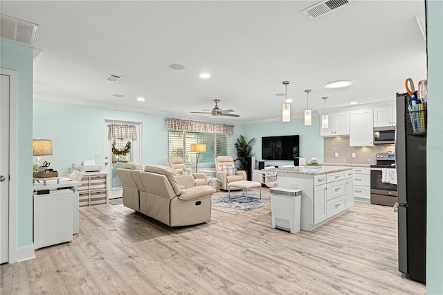 living room with ceiling fan, ornamental molding, and light hardwood / wood-style flooring