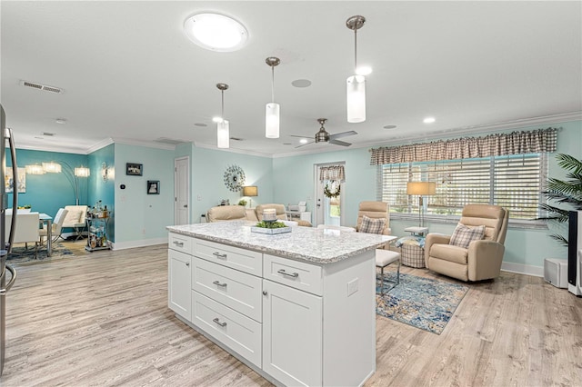 kitchen featuring light hardwood / wood-style flooring, hanging light fixtures, crown molding, white cabinetry, and ceiling fan