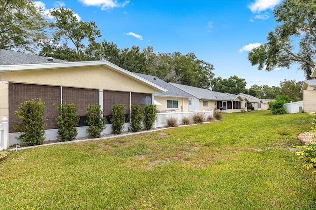 view of side of property with a lawn