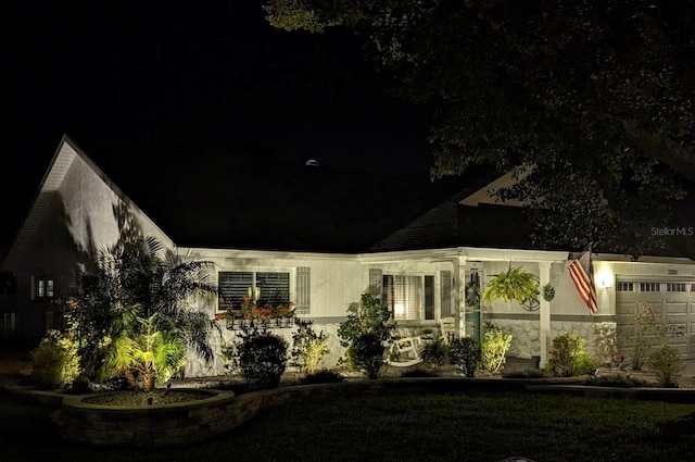 property exterior at twilight featuring a garage