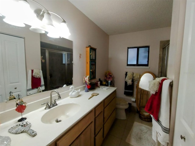 bathroom with a shower with door, tile patterned floors, toilet, vanity, and a textured ceiling