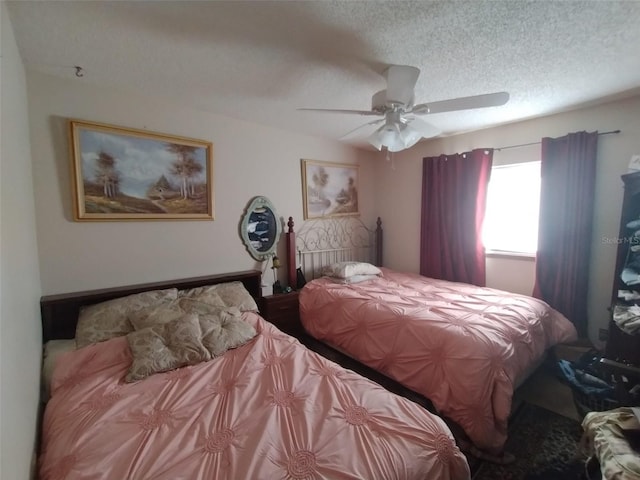 bedroom featuring a textured ceiling and ceiling fan