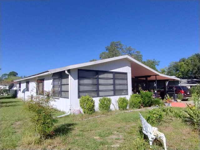 view of home's exterior with a lawn